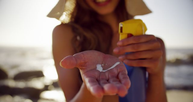 Woman Applying Sunscreen at Beach on Sunny Day - Download Free Stock Images Pikwizard.com