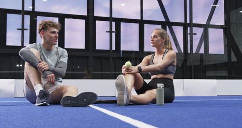Fit Friends Chatting on Blue Tennis Court Post Workout