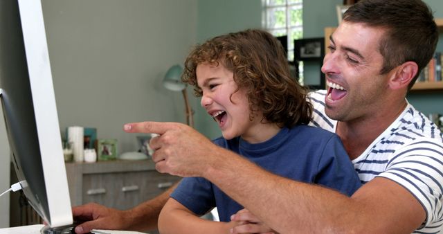 Father and Daughter Laughing While Using Computer at Home - Download Free Stock Images Pikwizard.com