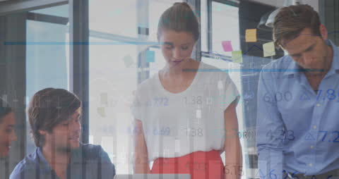 Business Team Analyzing Financial Data Overlayed with Stock Trends