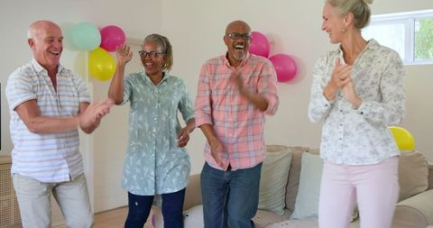 Senior Friends Joyfully Dancing at Home Celebration