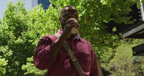 Man Drinking Coffee Outdoors in Urban Environment