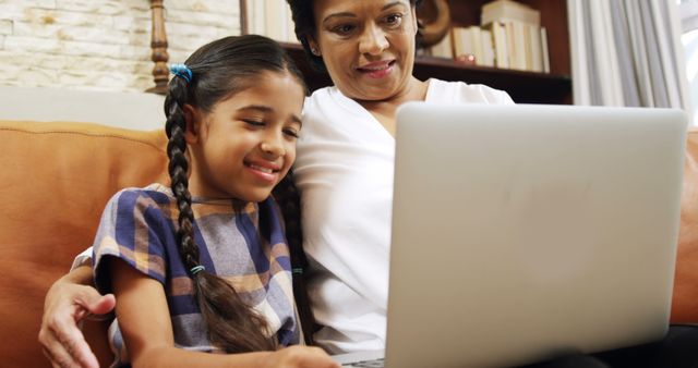 Smiling Girl and Grandmother Using Laptop Together at Home - Download Free Stock Images Pikwizard.com