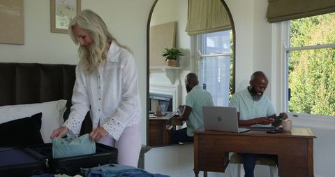Mature Couple Packing for a Relaxing Vacation