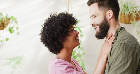 Happy Diverse Couple Embracing at Home in Sunlit Living Room - Download Free Stock Images Pikwizard.com