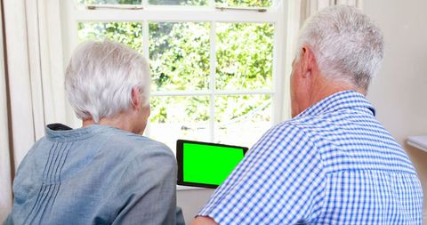 Elderly Couple Enjoying Tablet Together at Home