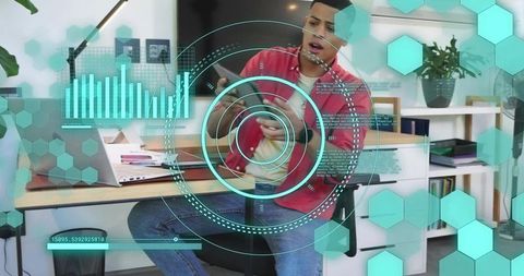 Young man checking smartphone at home office with teal hud interface overlay