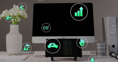 Sustainable minimalist office workspace showing green eco icons on desktop and tablet
