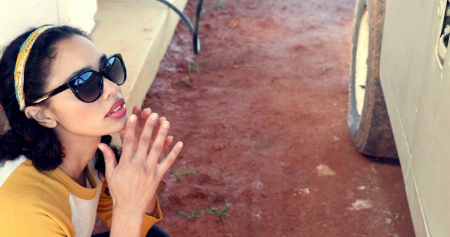 Thoughtful Woman Outdoors Wearing Sunglasses and Yellow Headband - Download Free Stock Images Pikwizard.com