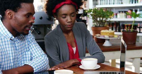 Coffee Shop Meeting with Laptop and Drinks