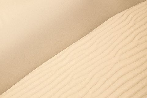 Abstract minimal diagonal sand dunes with rippling texture and smooth gradient composition