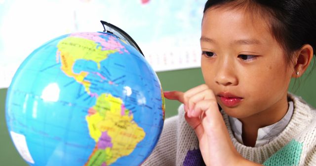 Young Student Learning About Geography by Studying Globe - Download Free Stock Images Pikwizard.com