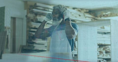 Skilled craftsman adjusting earmuffs in rustic woodworking workshop