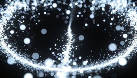 Glowing particle ring forming rising energy column in dark space with blue bokeh light