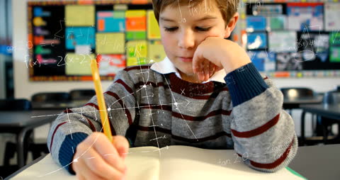 Caucasian Boy Focusing on Schoolwork with Math Animations