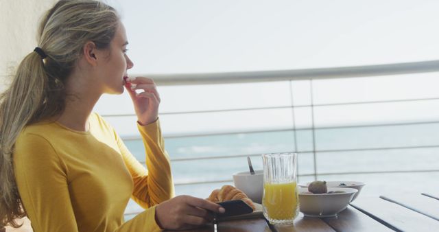 Woman Enjoying Breakfast on Balcony with Ocean View - Download Free Stock Images Pikwizard.com