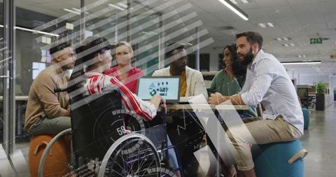 Inclusive Teamwork in Modern Workplace with Digital Charts Overlay