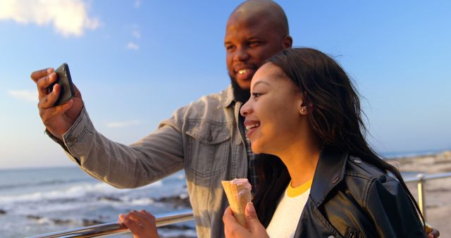 African American Couple Taking Selfies by Ocean During Sunset - Download Free Stock Images Pikwizard.com