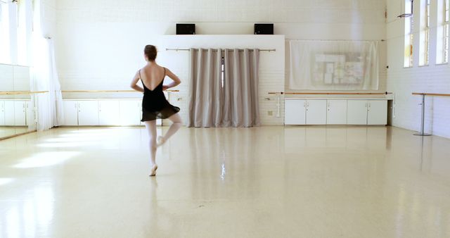 Ballerina is dancing in a dance hall 