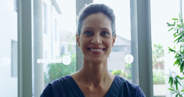 Smiling Female Healthcare Professional in Clinic Setting - Download Free Stock Images Pikwizard.com