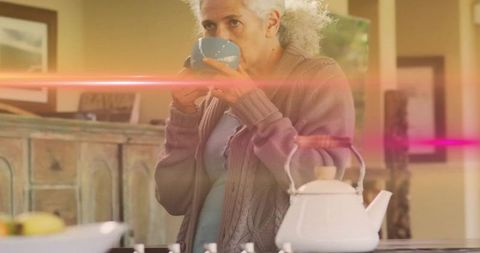 Senior Woman Sipping Mug in Cozy Home Kitchen Interior