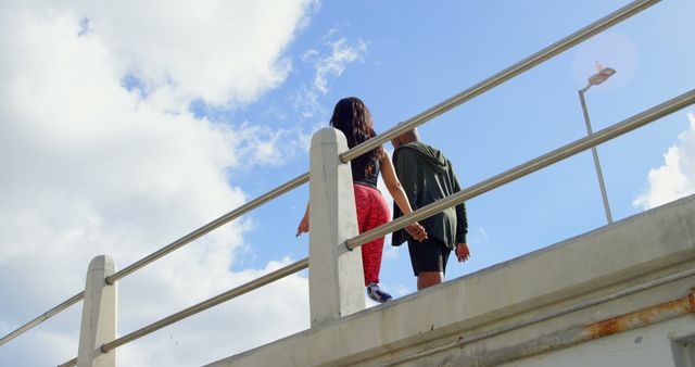 Couple Walking on Bridge with Blue Sky and Clouds - Download Free Stock Images Pikwizard.com