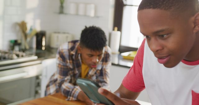 Two Young Men Using Smartphones in Modern Kitchen - Download Free Stock Images Pikwizard.com