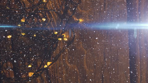 Snowfall Over Festive String Lights on Wooden Background