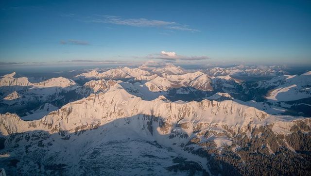 Golden sunlight over snow-covered mountain peaks