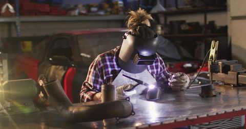 Female Welder at Work in Automotive Repair Shop