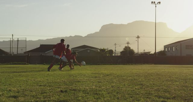 Young Soccer Players Training on Field in Sunset Light - Download Free Stock Images Pikwizard.com