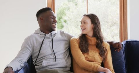 Happy Interracial Couple Relaxing at Home Smiling