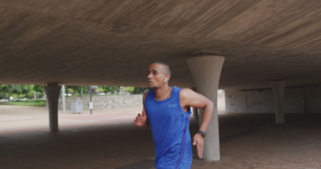 Determined Man Running Outdoors Wearing Earbuds - Download Free Stock Images Pikwizard.com