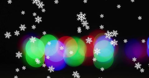 Snowflakes Falling Over Colorful Bokehs on Black Background