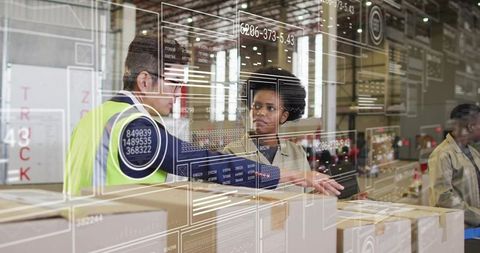 Warehouse team collaborating on inventory management inspecting cartons with tablet overlays
