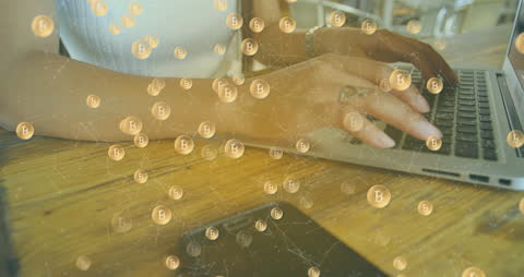 Female Professional Using Laptop with Bitcoin Overlay in Office Environment