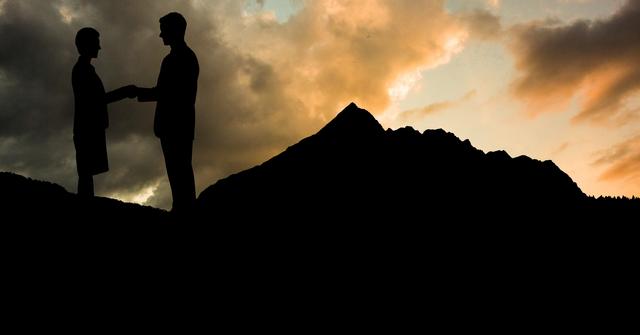 Silhouette of Business Partners Shaking Hands at Sunset in Mountains - Download Free Stock Photos Pikwizard.com