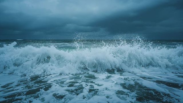 Tempestuous ocean waves crashing at shoreline, dramatic teal sea spray and foam