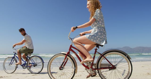 Young Couple Enjoying Beach Bike Ride on Sunny Day - Download Free Stock Images Pikwizard.com
