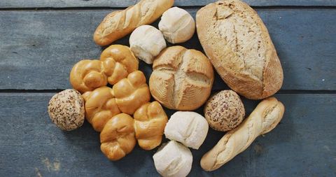 Assorted freshly baked artisan breads on rustic table
