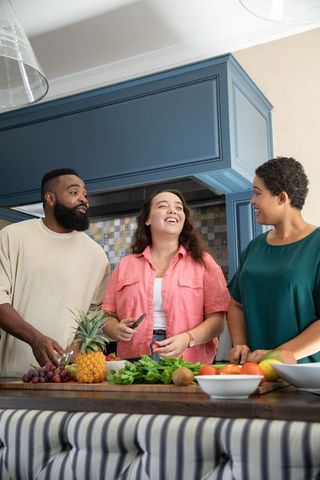 Diverse Friends Preparing Healthy Meal Together in Modern Kitchen