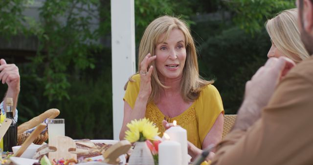 Elderly Woman Enjoying Outdoor Family Dinner - Download Free Stock Images Pikwizard.com