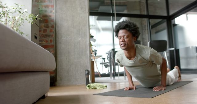 Young afro man practicing yoga in modern indoor space - Download Free Stock Images Pikwizard.com