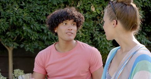 Friends Chatting Outdoors in Garden Setting