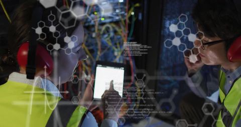 Technicians analyzing digital data in server room with innovative overlays