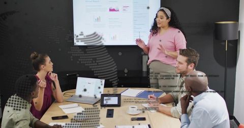 Business team in boardroom presenting analytics and charts during collaborative meeting