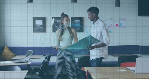 Designers collaborating on data visualization project in coworking office