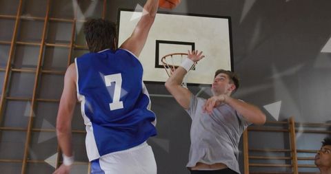 Intense basketball game action with forward shooting