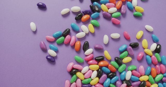 Colorful Jelly Beans Scattered on Purple Surface - Download Free Stock Images Pikwizard.com