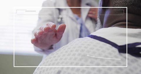 Physician placing stethoscope on patient shoulder during clinical examination